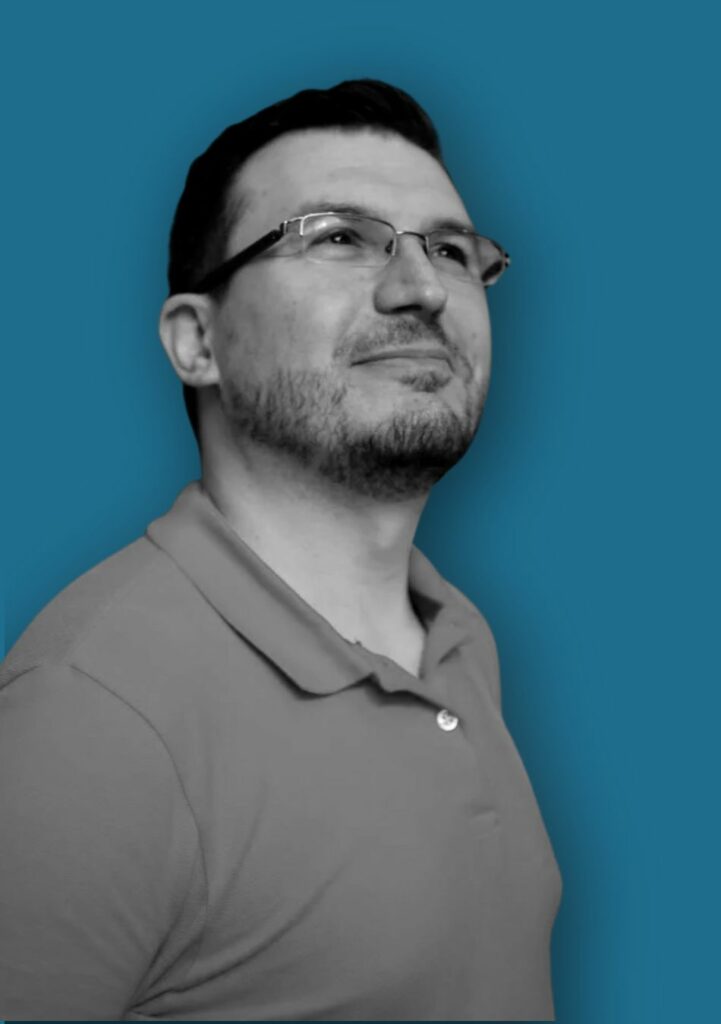 Matteo Greco, WordPress developer, smiling and looking up